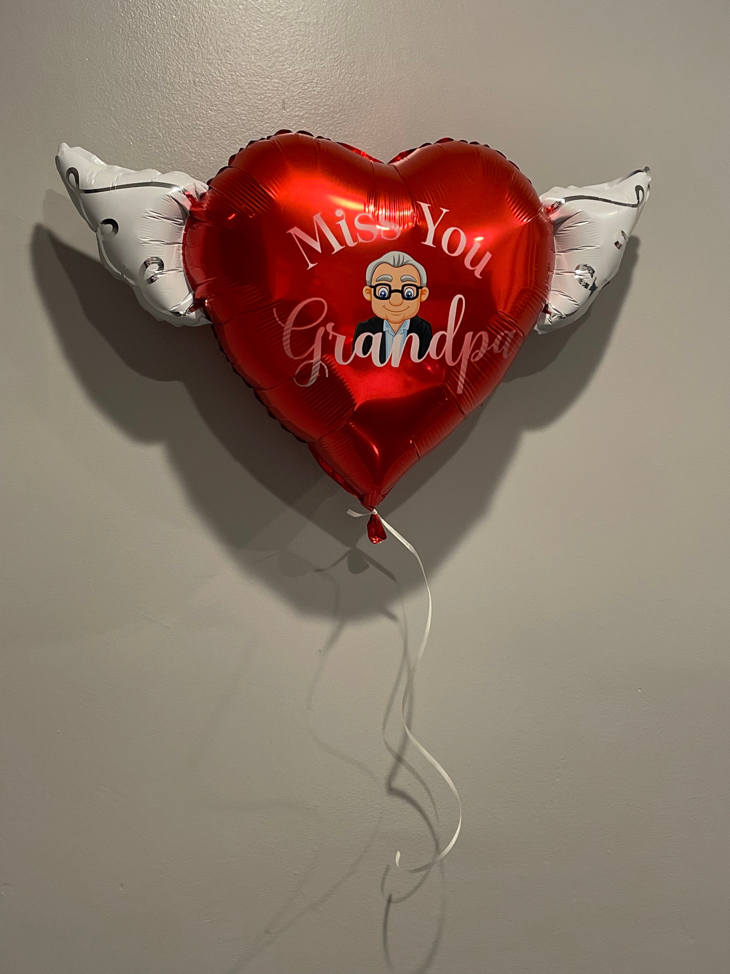 Inflated miss You Grandpa Memorial Balloon displayed on a wall – view 2