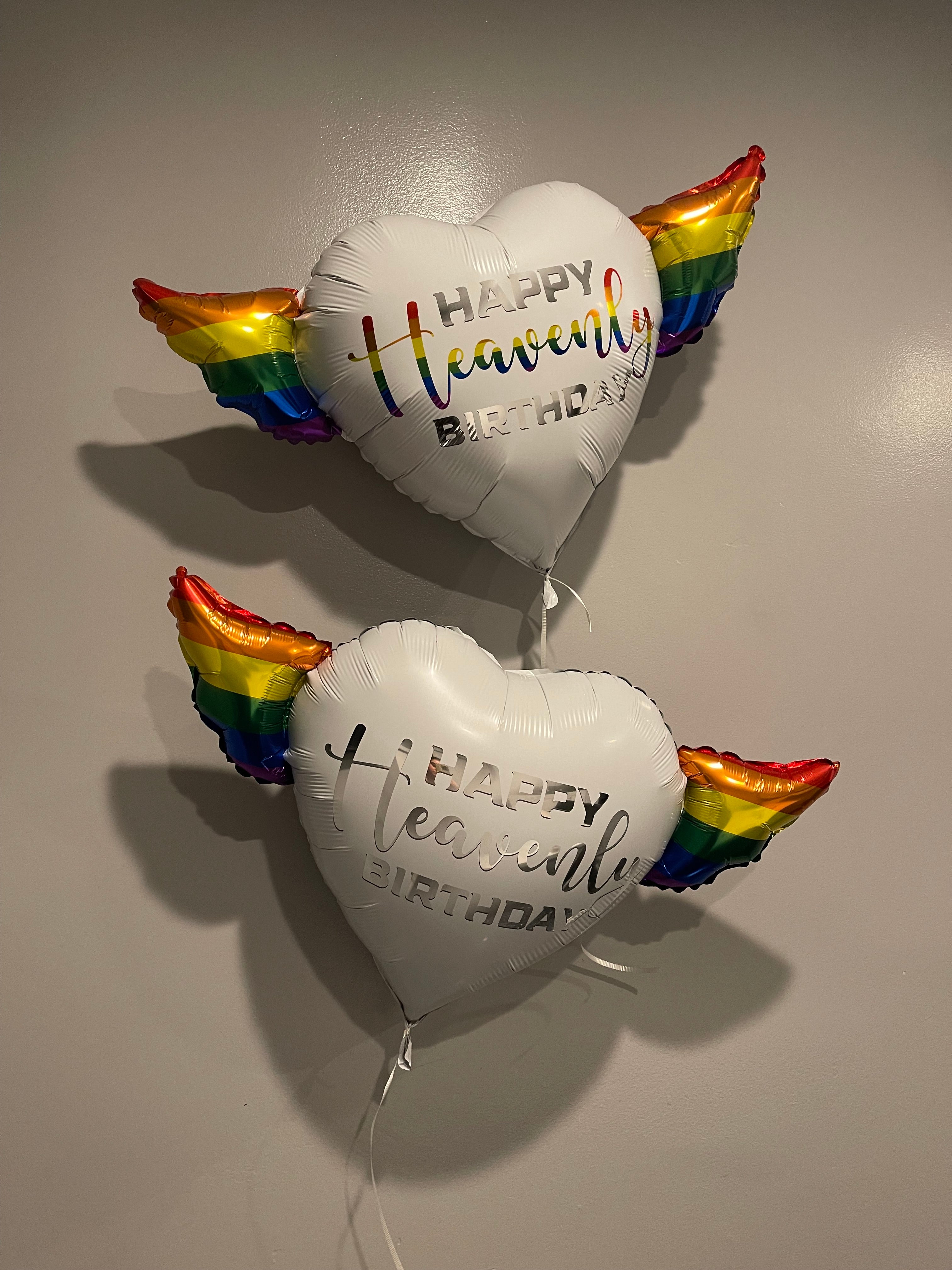 LGBTQ Happy Heavenly Birthday Heart Shaped Balloons with colorful angel wings with the word "Heavenly" in silver or "Heavenly" colorful