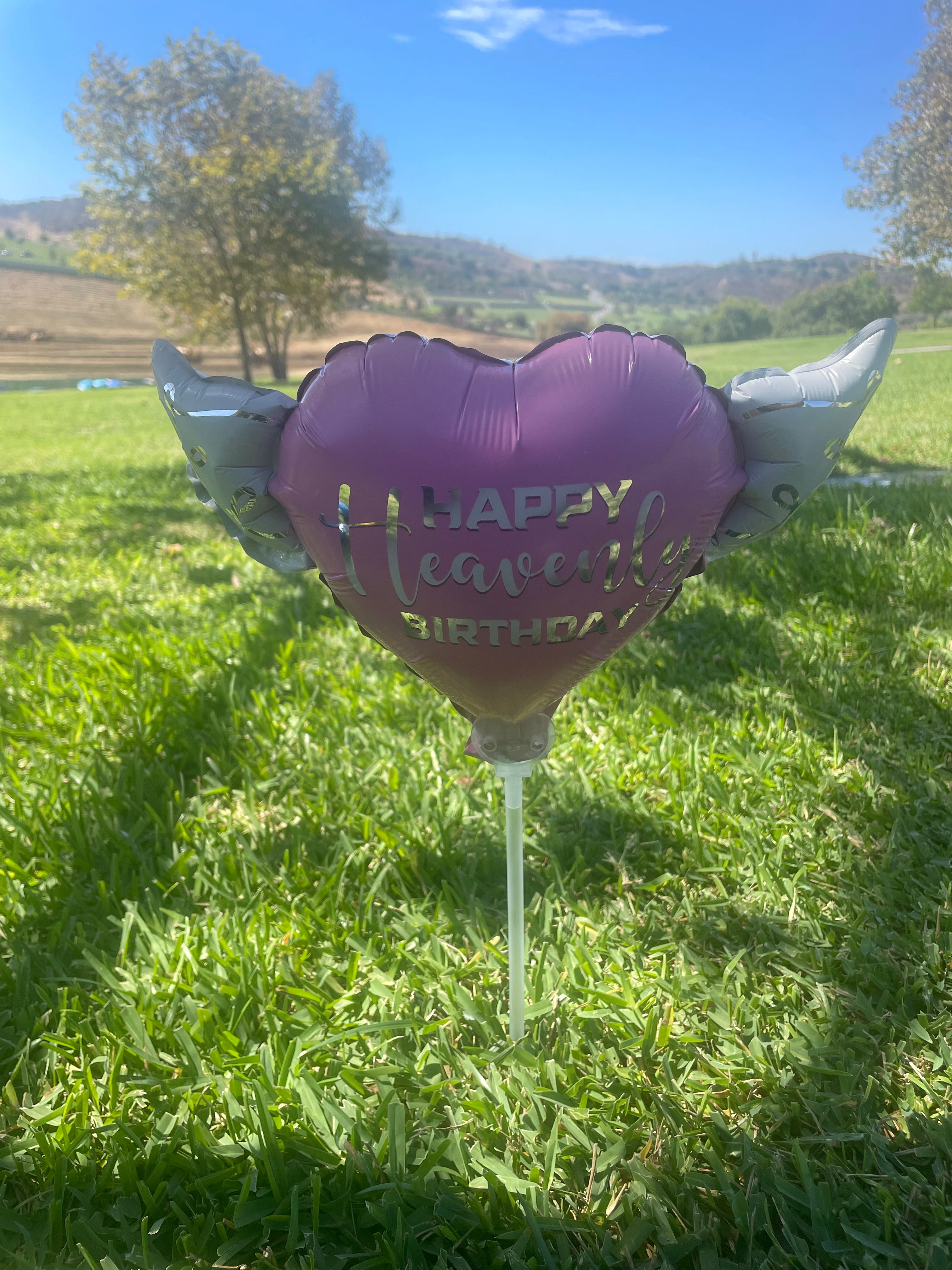 Happy Heavenly Birthday pink balloons on a stick heart shaped with angel wings